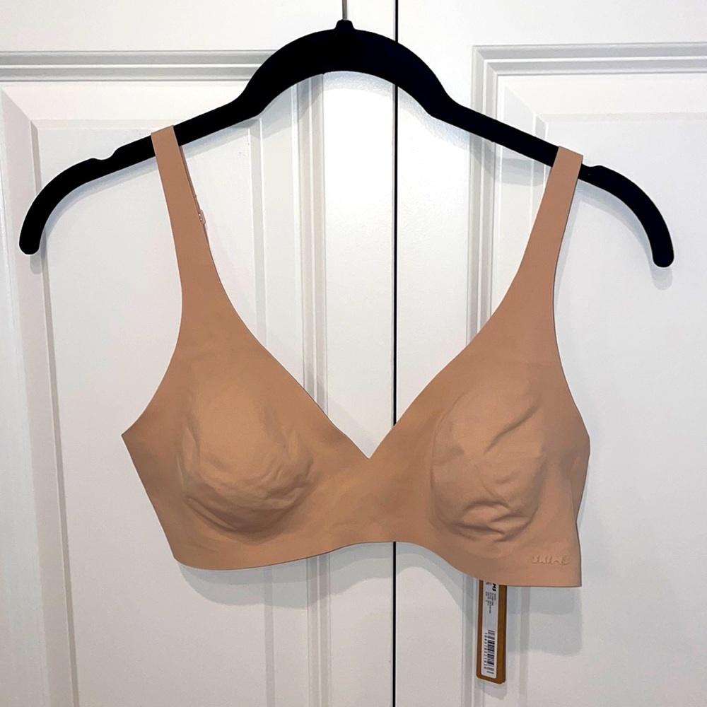 Skims Naked Plunge Bra in color mica.